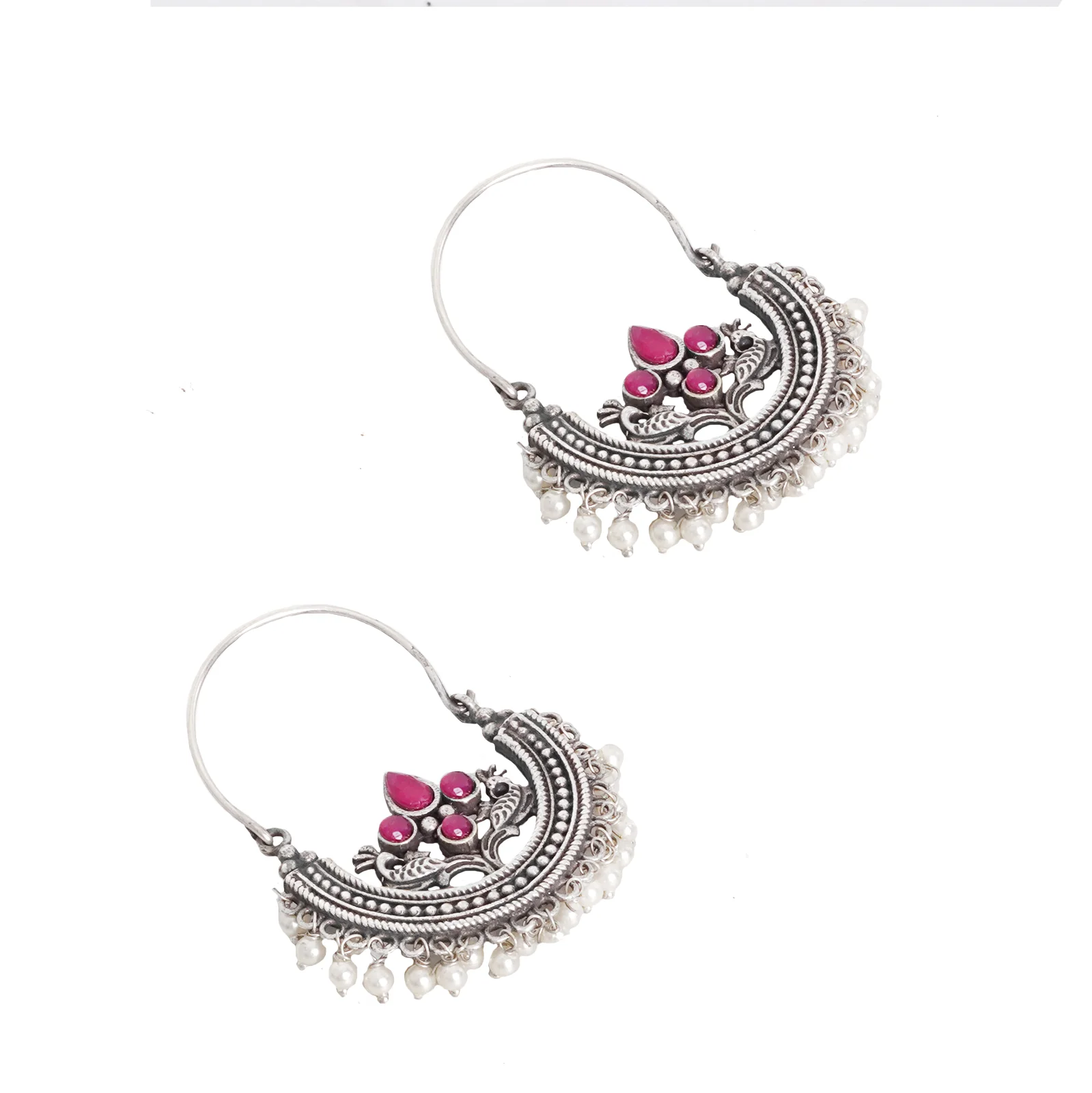 Angled view of Saara oxidised hoop earrings showing the crescent frame, red stones and pearl fringe